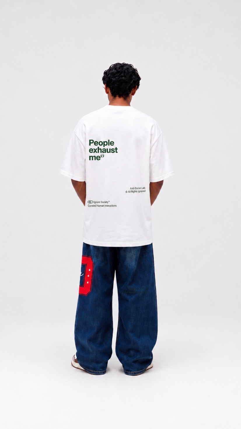 Person wearing a white t-shirt with text on the back, standing against a white background
