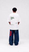 Person wearing a white t-shirt with text on the back, standing against a white background