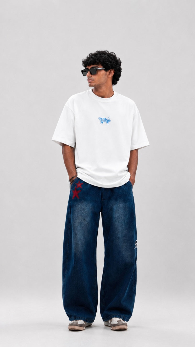 Person wearing a white t-shirt with a blue graphic design on the back, standing against a plain background.